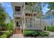 Charming home featuring a double porch, brick accents, and meticulous landscaping, enhancing its curb appeal at 202 Caldwell Ln, Davidson, NC 28036