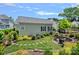 Charming backyard with a stone patio and seating area, surrounded by lush landscaping at 202 Caldwell Ln, Davidson, NC 28036