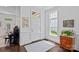 Bright foyer featuring dark wood floors, white walls, and natural light creating an elegant and welcoming entrance at 202 Caldwell Ln, Davidson, NC 28036