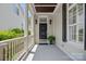 Welcoming front porch with classic columns, black door, and decorative planters, creating a charming entrance at 202 Caldwell Ln, Davidson, NC 28036