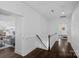 Bright hallway featuring hardwood floors, white trim, and a view into adjacent rooms at 202 Caldwell Ln, Davidson, NC 28036