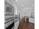 Modern kitchen featuring stainless steel appliances, granite countertops, and hardwood floors at 202 Caldwell Ln, Davidson, NC 28036