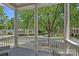 Serene porch view framed by white columns and railings, overlooking lush greenery and a peaceful neighborhood street at 202 Caldwell Ln, Davidson, NC 28036