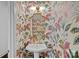 Charming powder room featuring vibrant floral wallpaper, a pedestal sink, and decorative fixtures at 202 Caldwell Ln, Davidson, NC 28036