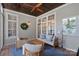 Well-lit sunroom with stylish furnishings and a unique ceiling, creating a cozy and inviting space at 202 Caldwell Ln, Davidson, NC 28036