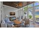 Comfortable sunroom featuring a vaulted ceiling, ceiling fan, and ample natural light from the surrounding windows at 202 Caldwell Ln, Davidson, NC 28036