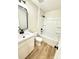 Bright bathroom featuring a tub shower, modern vanity, matte black hardware and vinyl flooring at 203 Putnam St, Shelby, NC 28152