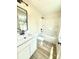 Clean bathroom featuring a tub shower, modern vanity, matte black hardware and vinyl flooring at 203 Putnam St, Shelby, NC 28152