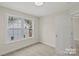 Well-lit bedroom boasts a neutral color scheme, plush carpet, and natural light at 203 Putnam St, Shelby, NC 28152