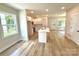 Modern kitchen featuring white cabinets, stainless steel appliances, and an island with seating at 203 Putnam St, Shelby, NC 28152