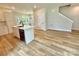 Kitchen island with stainless steel dishwasher and a view into the dining area and staircase at 203 Putnam St, Shelby, NC 28152