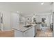 Open-concept kitchen flows into the living room, featuring granite counters, stainless appliances, and wooden floors at 203 Putnam St, Shelby, NC 28152