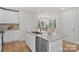 Bright kitchen with white cabinets, granite counters, stainless steel appliances and wooden floors at 203 Putnam St, Shelby, NC 28152