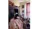 Cluttered bedroom featuring an armoire stacked with personal items at 2056 Evergreen Dr, Newton, NC 28658