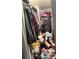 Messy walk-in closet overloaded with clothes, boxes, and personal belongings at 2056 Evergreen Dr, Newton, NC 28658