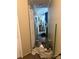Cluttered hallway with items strewn on the floor and walls needing repair at 2056 Evergreen Dr, Newton, NC 28658