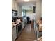Messy kitchen with outdated appliances and a view toward another cluttered room at 2056 Evergreen Dr, Newton, NC 28658