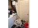 Disorganized laundry room featuring a washer and dryer, along with scattered clutter and items on the floor at 2056 Evergreen Dr, Newton, NC 28658