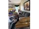 Untidy living room featuring a grey sofa, artwork, boxes, and various cluttered items at 2056 Evergreen Dr, Newton, NC 28658