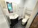 Bathroom with new black and white hexagonal tile, with matching vanity at 2115 Arnold Dr, Charlotte, NC 28205