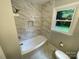 Bathroom featuring a tiled shower and garden window at 2115 Arnold Dr, Charlotte, NC 28205