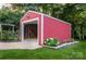 Exterior view of the red garage, featuring a flowerbed, concrete driveway, and an open garage door at 2115 Arnold Dr, Charlotte, NC 28205