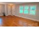 Inviting living room with hardwood floors, white trim, natural light and a view of the front yard at 2115 Arnold Dr, Charlotte, NC 28205