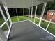 Open screened porch featuring a painted deck and backyard views at 2115 Arnold Dr, Charlotte, NC 28205