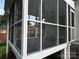 Rear screened porch with brick supports and painted wood flooring at 2115 Arnold Dr, Charlotte, NC 28205
