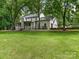 Spacious backyard with lush green lawn and view of the home's exterior at 2141 Halford Pl, Charlotte, NC 28211