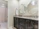 Bathroom with double sink vanity with granite countertop and modern mirrors at 2141 Halford Pl, Charlotte, NC 28211
