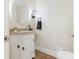Charming powder room with granite countertop, decorative mirror, and stylish light fixture at 2141 Halford Pl, Charlotte, NC 28211