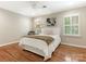 Bedroom featuring hardwood floors, white shuttered windows, and a cozy bed at 2141 Halford Pl, Charlotte, NC 28211