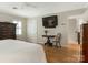 Bright bedroom featuring hardwood floors, a ceiling fan, and large dresser at 2141 Halford Pl, Charlotte, NC 28211