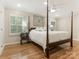 Bedroom with a four-poster bed, ceiling fan, and light hardwood floors at 2141 Halford Pl, Charlotte, NC 28211
