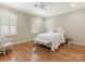 Bedroom with hardwood floors, two shuttered windows, and a ceiling fan at 2141 Halford Pl, Charlotte, NC 28211
