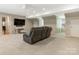 Cozy basement living room with plush carpeting and leather reclining sofa at 2141 Halford Pl, Charlotte, NC 28211