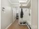 Well-organized mudroom with bench seating and storage for shoes and coats at 2141 Halford Pl, Charlotte, NC 28211