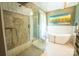 Bright bathroom with large glass shower, a soaking tub, and modern finishes for a spa-like feel at 215 W Eastway Drive Dr, Charlotte, NC 28213