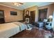 Comfortable bedroom features hardwood floors, fireplace, and a leather chaise lounge, providing an inviting space at 215 W Eastway Drive Dr, Charlotte, NC 28213