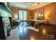 Cozy bedroom with a fireplace, hardwood floors, and soft, warm lighting at 215 W Eastway Drive Dr, Charlotte, NC 28213