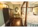 View of a bedroom, complete with hardwood floors, a four poster bed, and an antique dresser at 215 W Eastway Drive Dr, Charlotte, NC 28213