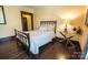Bedroom features hardwood flooring and glass-top side table at 215 W Eastway Drive Dr, Charlotte, NC 28213