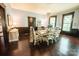 Inviting dining room featuring beautiful hardwood floors, wainscoting and a chandelier for a warm atmosphere at 215 W Eastway Drive Dr, Charlotte, NC 28213