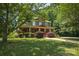Charming two-story home featuring a welcoming front porch and lush landscaping at 215 W Eastway Drive Dr, Charlotte, NC 28213