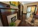 The living room displays a fireplace, hardwood floors, and an open doorway to another room at 215 W Eastway Drive Dr, Charlotte, NC 28213