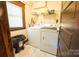 Functional laundry room featuring tile flooring and modern washer and dryer at 215 W Eastway Drive Dr, Charlotte, NC 28213