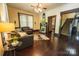 A living room features hardwood floors, a fireplace, and a glimpse of the staircase at 215 W Eastway Drive Dr, Charlotte, NC 28213