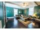 Cozy living room with teal walls, hardwood floors, stylish decor, and natural light at 215 W Eastway Drive Dr, Charlotte, NC 28213