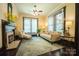 The living room showcases neutral walls, a ceiling fan, and two large windows at 215 W Eastway Drive Dr, Charlotte, NC 28213
